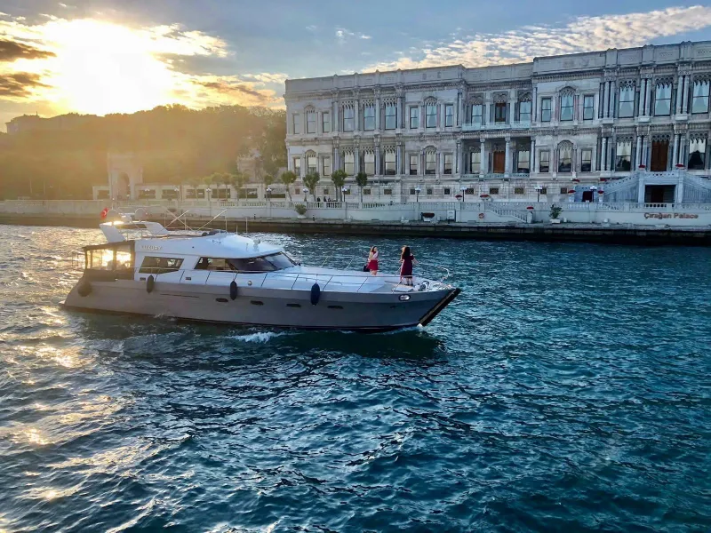 Private yacht tour in Istanbul, passing by the Çırağan Palace at sunset.