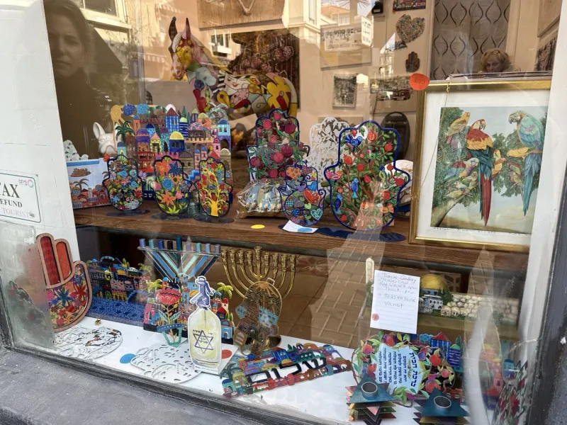 Colorful Israeli handicrafts displayed in a shop window in Jerusalem.