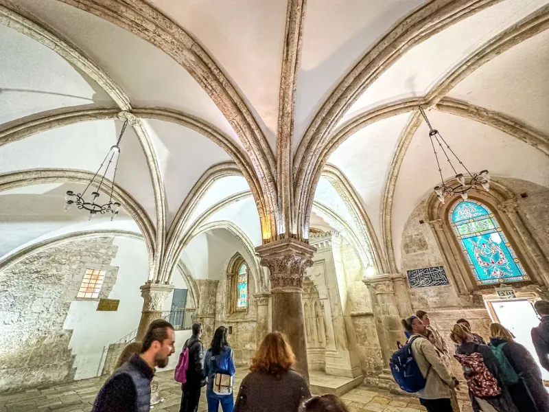 Tour group exploring the stunning architecture of a historic church in Jerusalem.