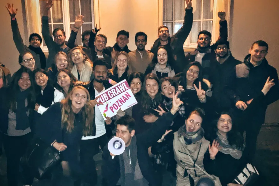 A large group enjoys a pub crawl tour in Poznan, Poland.