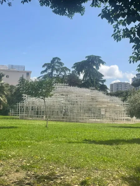 The Serpentine Pavilion in Rome, a stunning temporary installation in a green park.