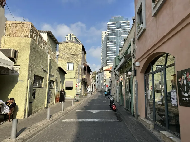 Peaceful street scene in Tel Aviv, Israel, showcasing charming architecture and local businesses.