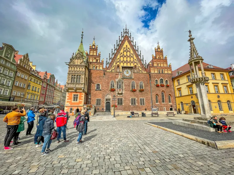 Tour group admiring the Old Town Hall in Wrocław's Market Square.