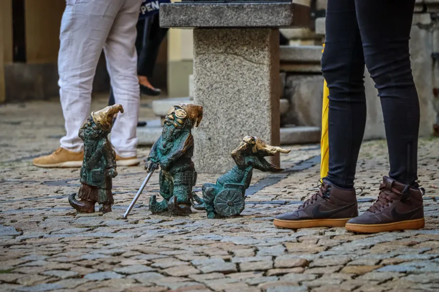 Three charming bronze gnomes in Wrocław, Poland.