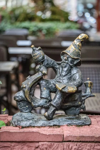 Bronze dwarf statue on a scooter in Wroclaw, Poland.