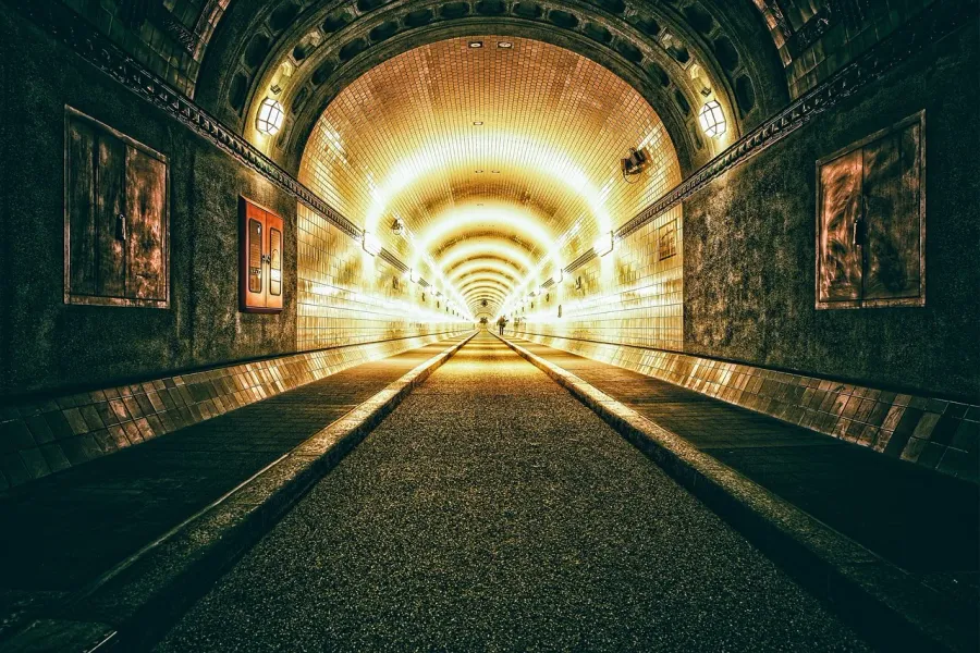 A long, illuminated tunnel invites exploration.