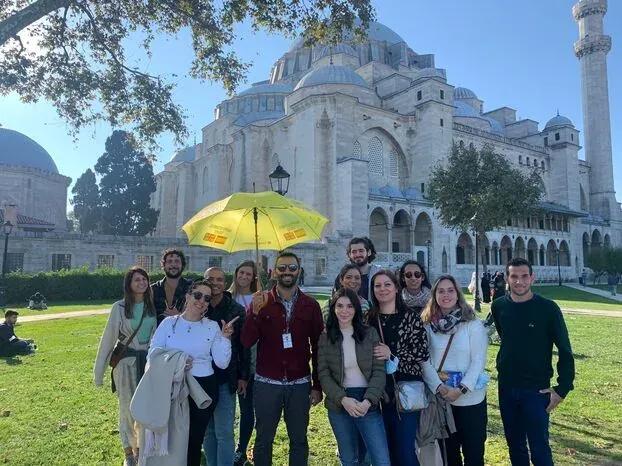 Happy tour group in front of the Süleymaniye Mosque in Istanbul.